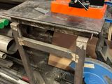 a workbench that has a lot of tools on it