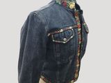 denim jacket on a mannequin base with a floral design
