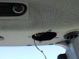 a hole in the ceiling of a car that has been damaged