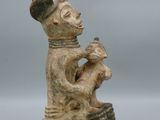 an image of a figurine of a man holding a cat