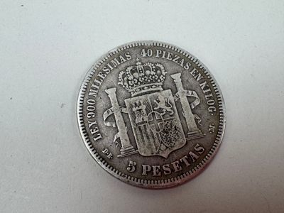 a close up of a coin on a table with a white background
