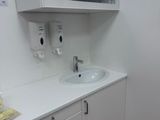 a bathroom with a sink, cabinets, and a mirror