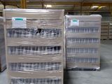 several pallets of water are stacked up in a warehouse