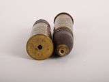 two old brass bullet shells on a white background