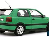 the green car is parked on the side of the road