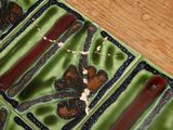 a close up of a green and black tray on a wooden table