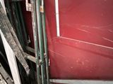 a picture of a room with a red wall and a window