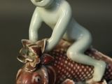 a figurine of a boy riding a fish