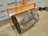 a close up of a roller on a stand with a sign in the background