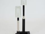 a black and white lamp that is on top of a table