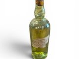 a bottle of alcohol that is sitting on a white surface