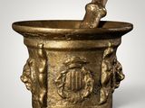 an image of a gold mortar with a pestula in it
