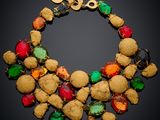a close up of a colorful necklace on a black surface