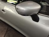 a car that has a side view mirror on the side of it