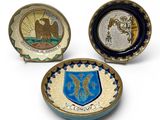 three small plates with a coat of arms and a coat of arms on them
