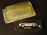 a plastic container with a silver car inside of it