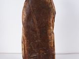 an old wooden statue of a man with a hat on his head
