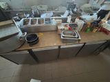 a picture of a kitchen with a lot of clutter on the counter