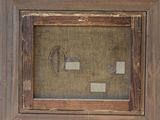 an old picture of a wooden frame with a picture in it