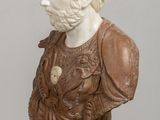 marble bust of a man in a brown dress with a flower in his hair