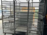 a large metal cart with many trays in it