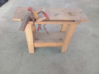 a wooden work bench with tools on top of it