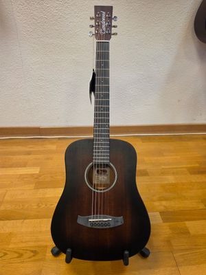 a guitar that is sitting on a stand on the floor