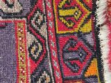 an image of a close up of a colorful rug on a white surface