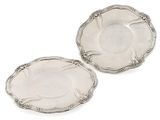 a pair of silver plated dishes on a white background