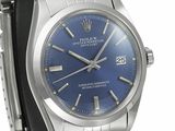 a close up of a wrist watch with a blue dial