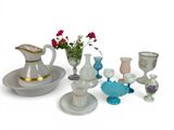 many different types of vases and dishes on the table