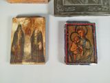 three small wooden boxes with religious paintings on them on a table