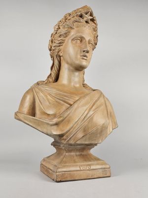 a carved bust of a woman wearing a headdress