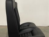 a close up of a black leather seat on a pallet