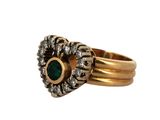 a close up of a gold ring with a green stone