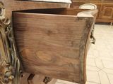 a bed that has a drawer on the side of it