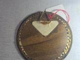 a wooden heart hanging on a string on a table