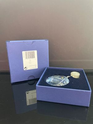une image représentant une boîte bleue contenant une décoration en verre