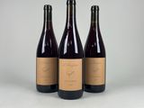 three bottles of wine sitting next to each other on a table