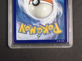 a pokemon card in a plastic case on a table