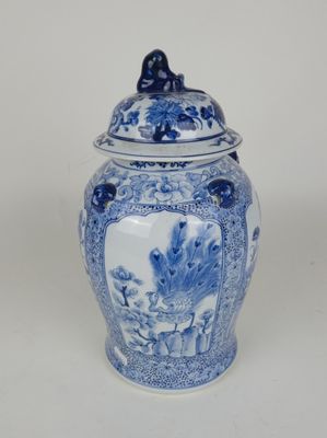 blue and white ginger jar with a lid with a bird on the lid