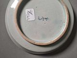 a plate with a tag on it sitting on a table
