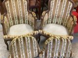 pair of antique chairs with gold and white striped upholstered cushions