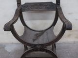 a wooden chair that is sitting in front of a wall