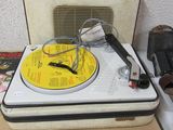a record player sitting on top of a suitcase