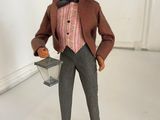 a figurine of a man wearing a hat and a suit