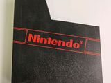 a close up of a nintendo logo on top of a box