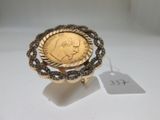 an image of a gold ring with a coin in the middle