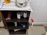 a bathroom with a sink, toilet, and a shelf in it