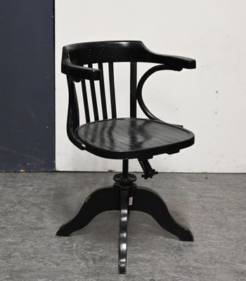 a black chair with a wooden seat on a metal stand